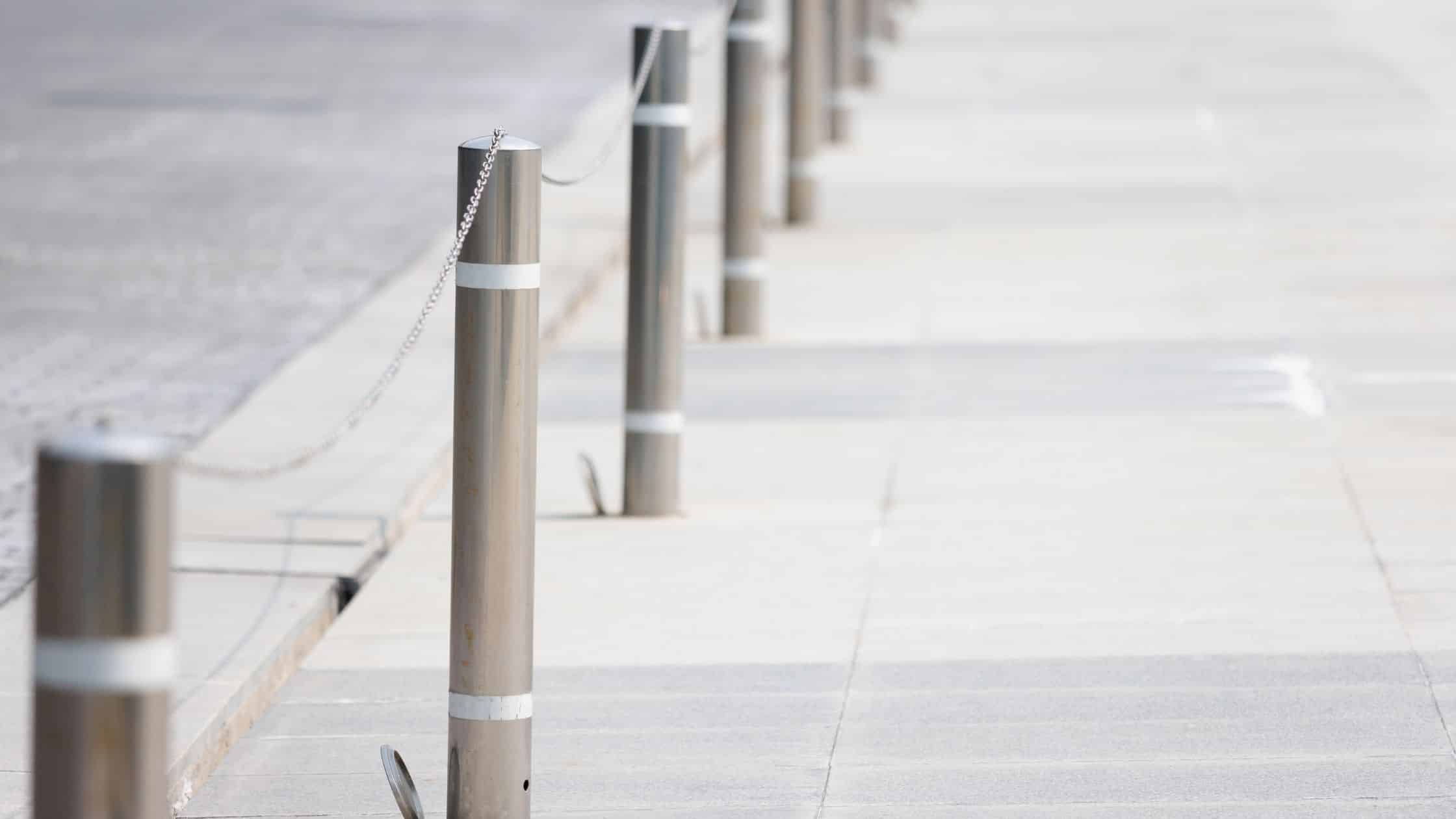 How Are Stainless Steel Bollards Made? stainless steel bollards with chain on footpath